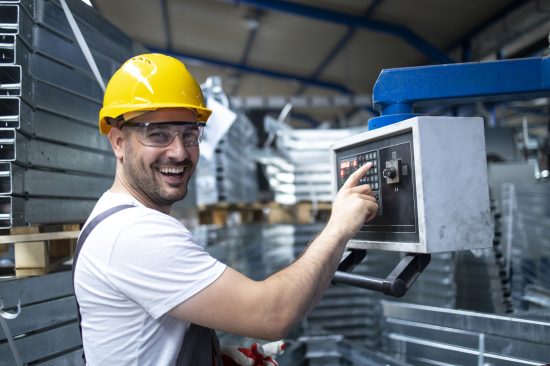 portrait-factory-worker-operating-industrial-machine-setting-parameters